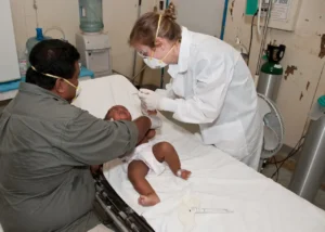 sick Baby Lying Down on Hospital Bed Getting a Check-up by a doctor