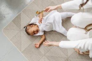 a Baby Girl lying on the Floor has febrile seizure