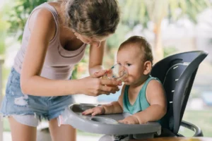 mother Assisting Baby for drinking water