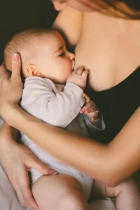 a mother giving breastfeeding to her baby