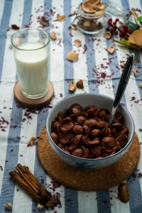 breakfast with chocolate cornflakes and milk glass
