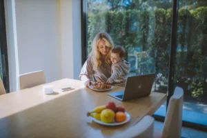 Woman With her Baby Having Breakfast