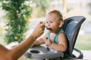 Baby Eating a types of weaning food On A Chair