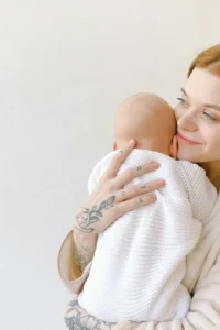 a mother giving burping to her newborn