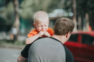 Man Carrying Child who has tantrum