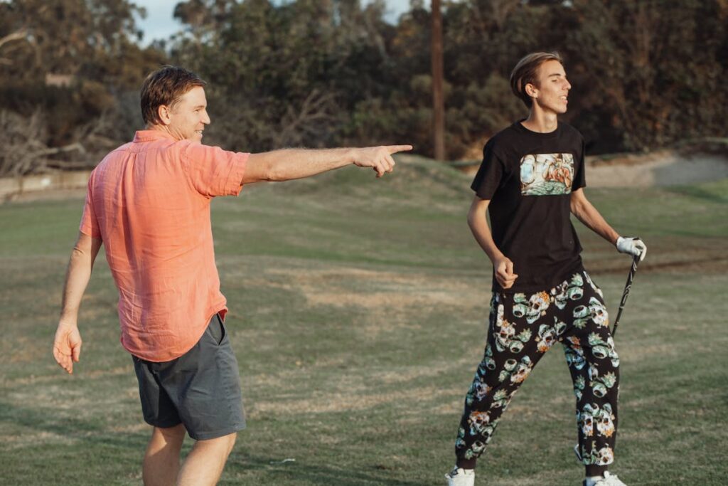 19 yrs boy and father playing a golf