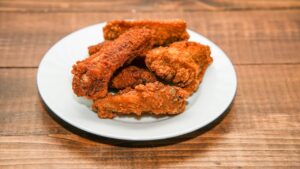 fried oily food served in a white plate