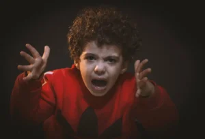 Toddler has tantrum With Red Adidas Sweat Shirt