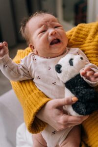 A baby crying due to colic pain and recurrent abdominal pain in childhood