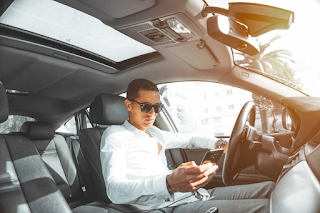 18 yrs boy checking his phone while driving a car