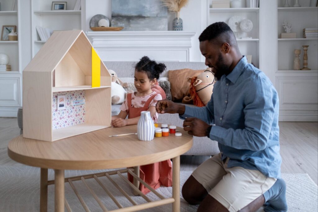 a father playing with his doughter to help in physical development in childhood