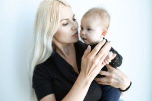a mother in black top with her 3 months baby