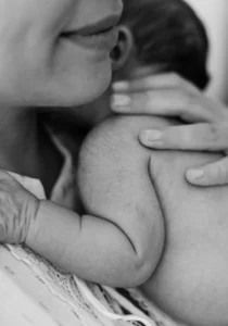 a newborn on the lap of mother