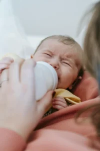 Photo of a Baby Crying taking bottle feeding
