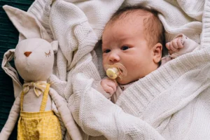 a baby with Newborn Pacifier in his mouth