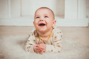 Baby Lying On floor and smiling