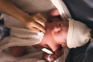 A NEWBORN (navjat shishu image and Skin )WRAPPED IN WHITE TOWEL