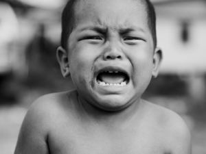 a crying boy Withholding posture is typical of functional constipation