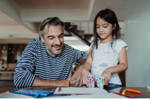 a father and his little doughter playing with indoor games and toys