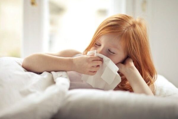 a girl child sneeezing and wipping her nose with clothe suffering from human metapneumovirus (hmpv)kya hai